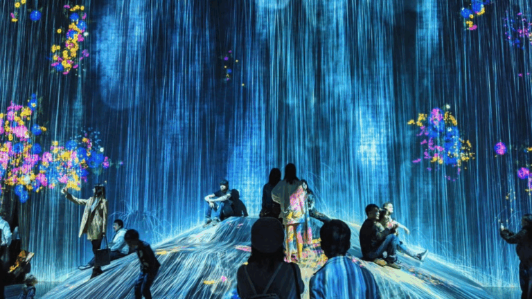 People sitting in a room with digital images projected onto them